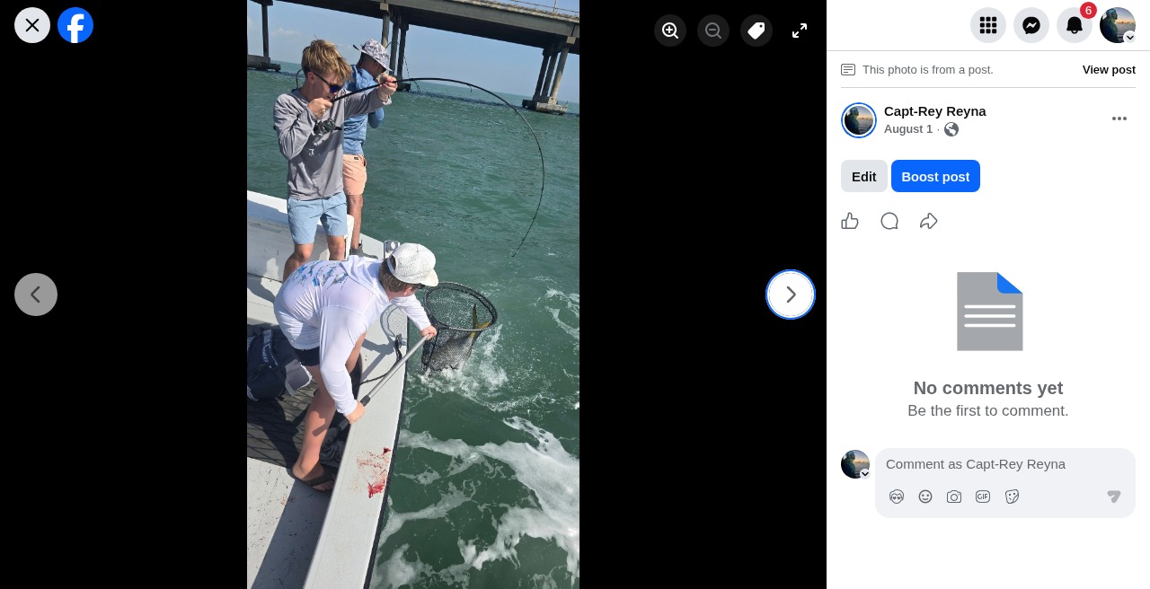 Capt. Rey netting a fish during a hookup